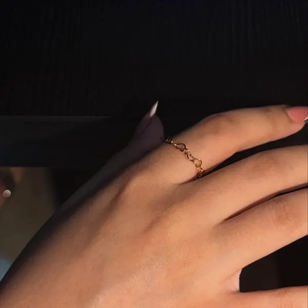 A delicate cable ring on a hand
